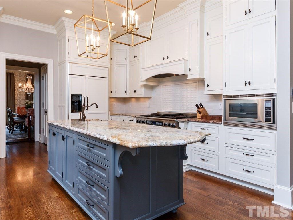 2305 Beechridge Road Raleigh, NC 27608 - Photo 8 of 24 a kitchen with granite countertop a sink a stove and cabinets