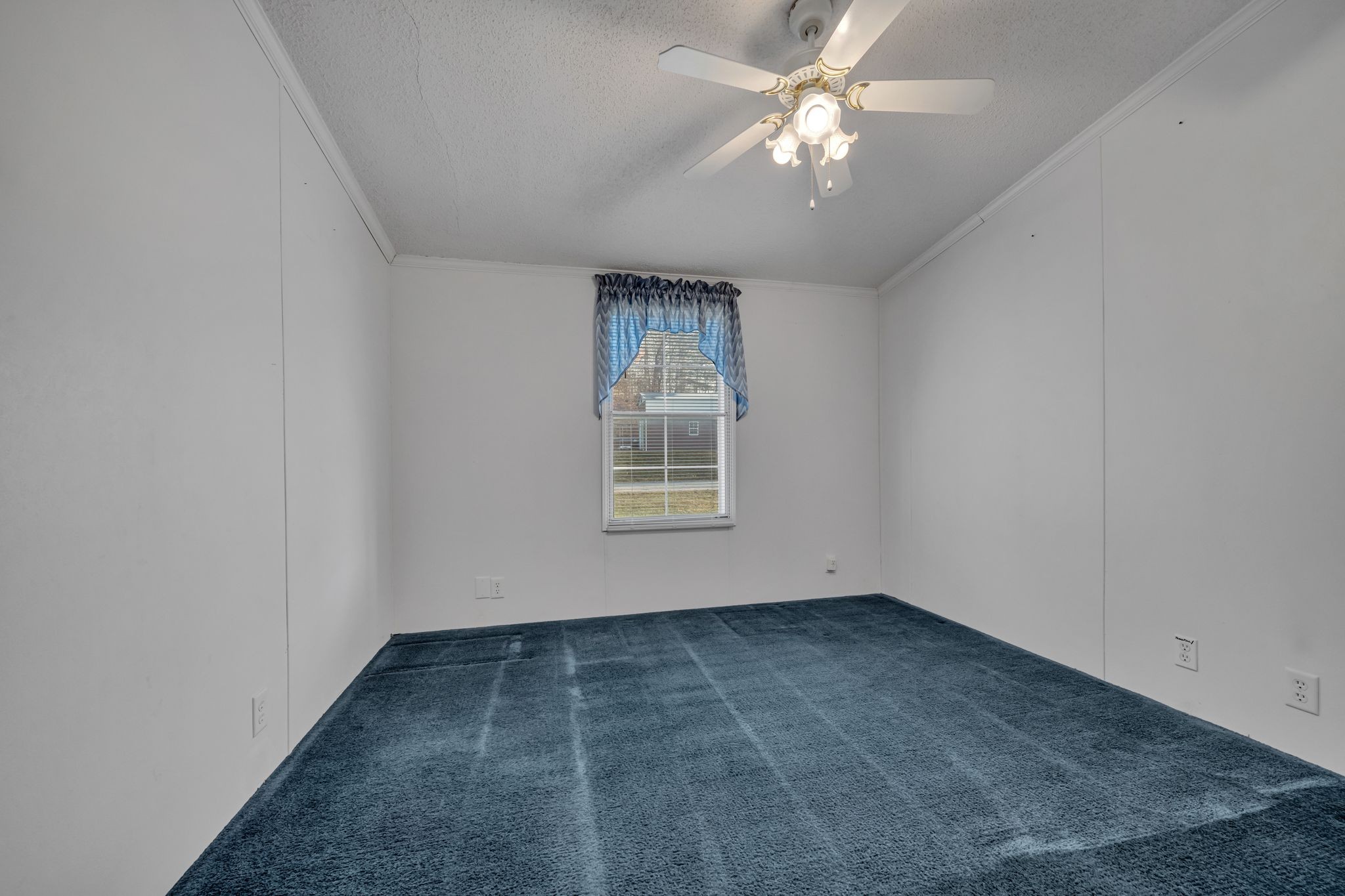 11364 Potts Hollow Road Lyles, TN 37098 - Photo 20 of 29 an empty room with a chandelier fan and windows