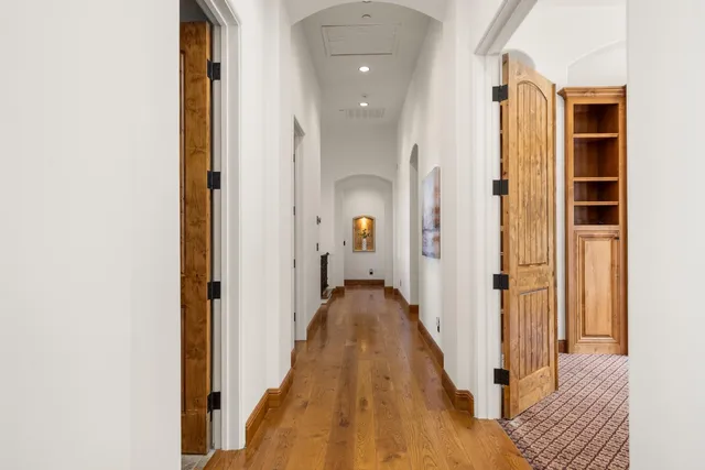 an empty room with closet and a ceiling fan