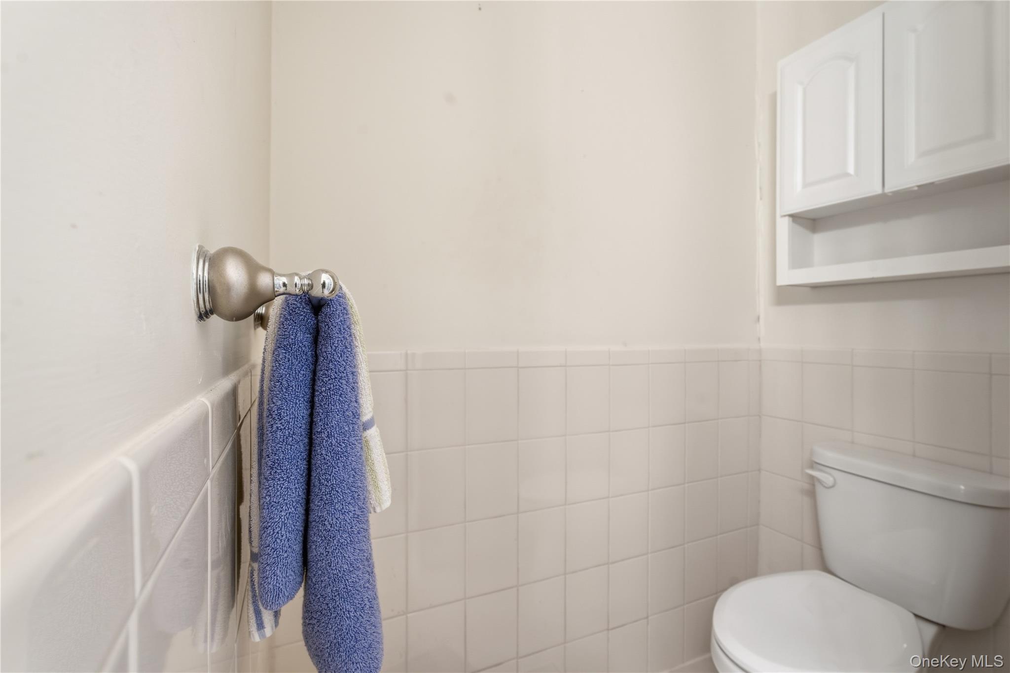 313 Mariners Way Copiague, NY 11726 - Photo 13 of 25 a bathroom with a toilet and a shower