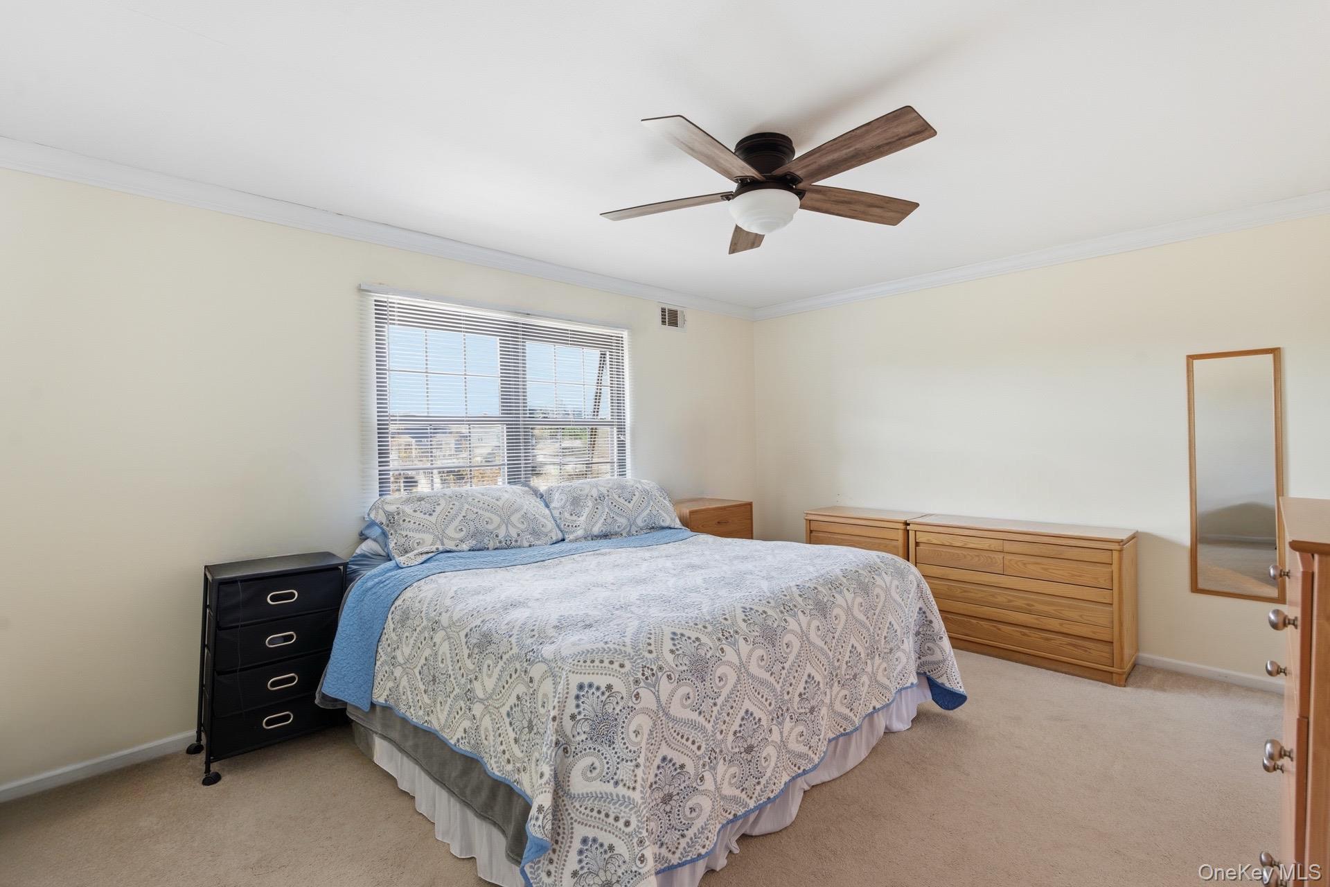 313 Mariners Way Copiague, NY 11726 - Photo 16 of 25 a bedroom with a bed and window