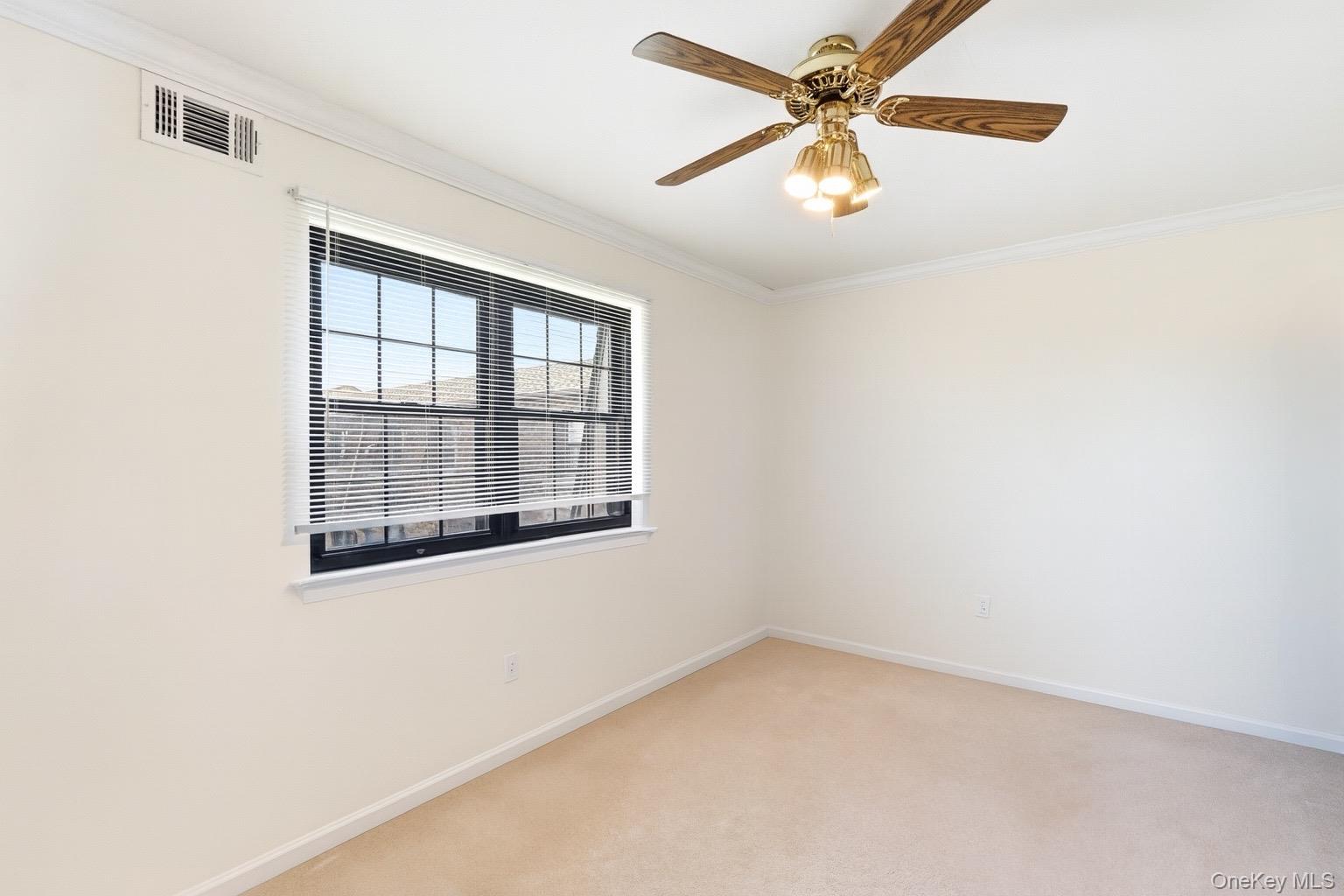313 Mariners Way Copiague, NY 11726 - Photo 18 of 25 an empty room with a window and a fan