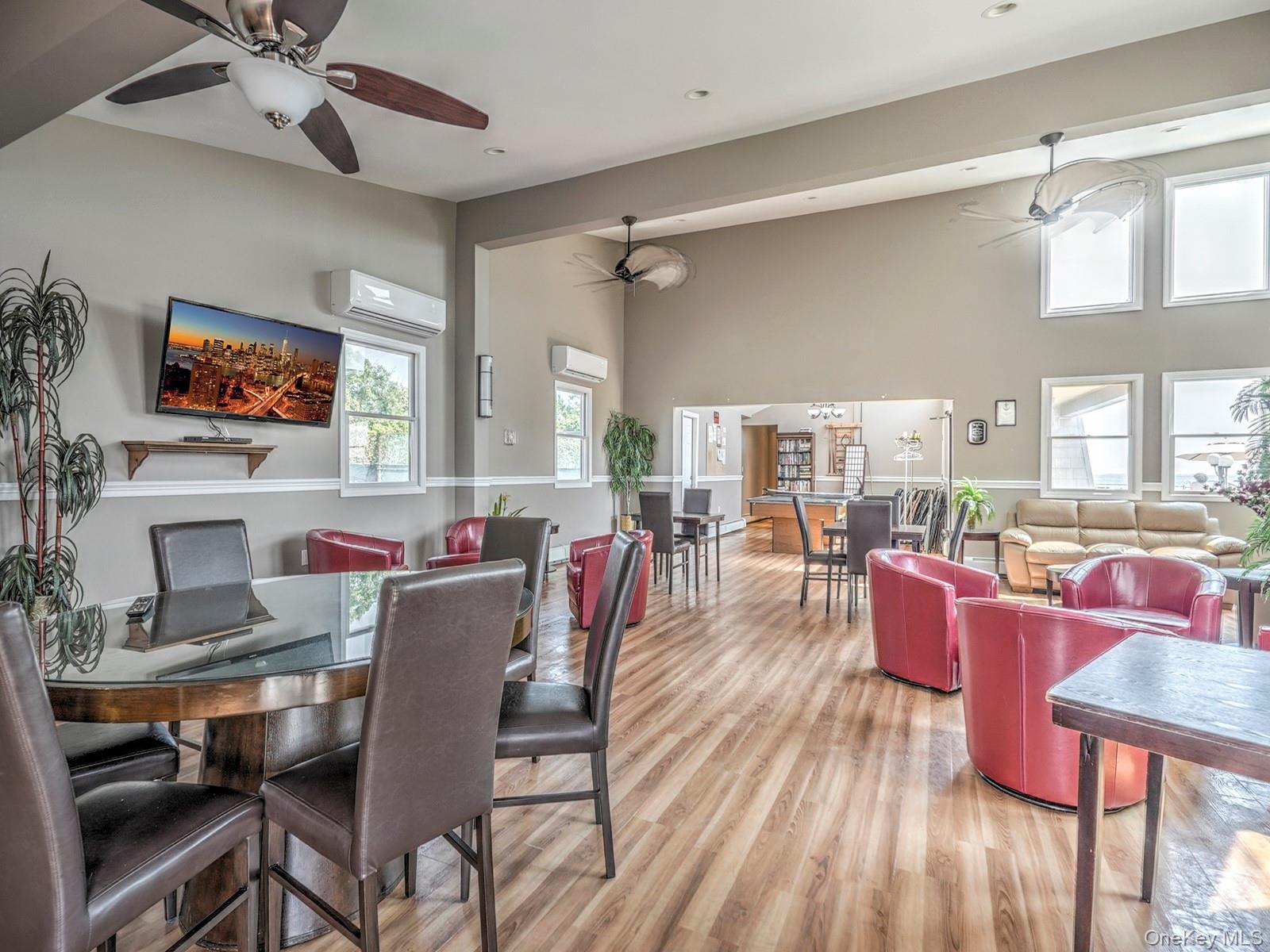 313 Mariners Way Copiague, NY 11726 - Photo 25 of 25 a dining room with furniture a fireplace and wooden floor