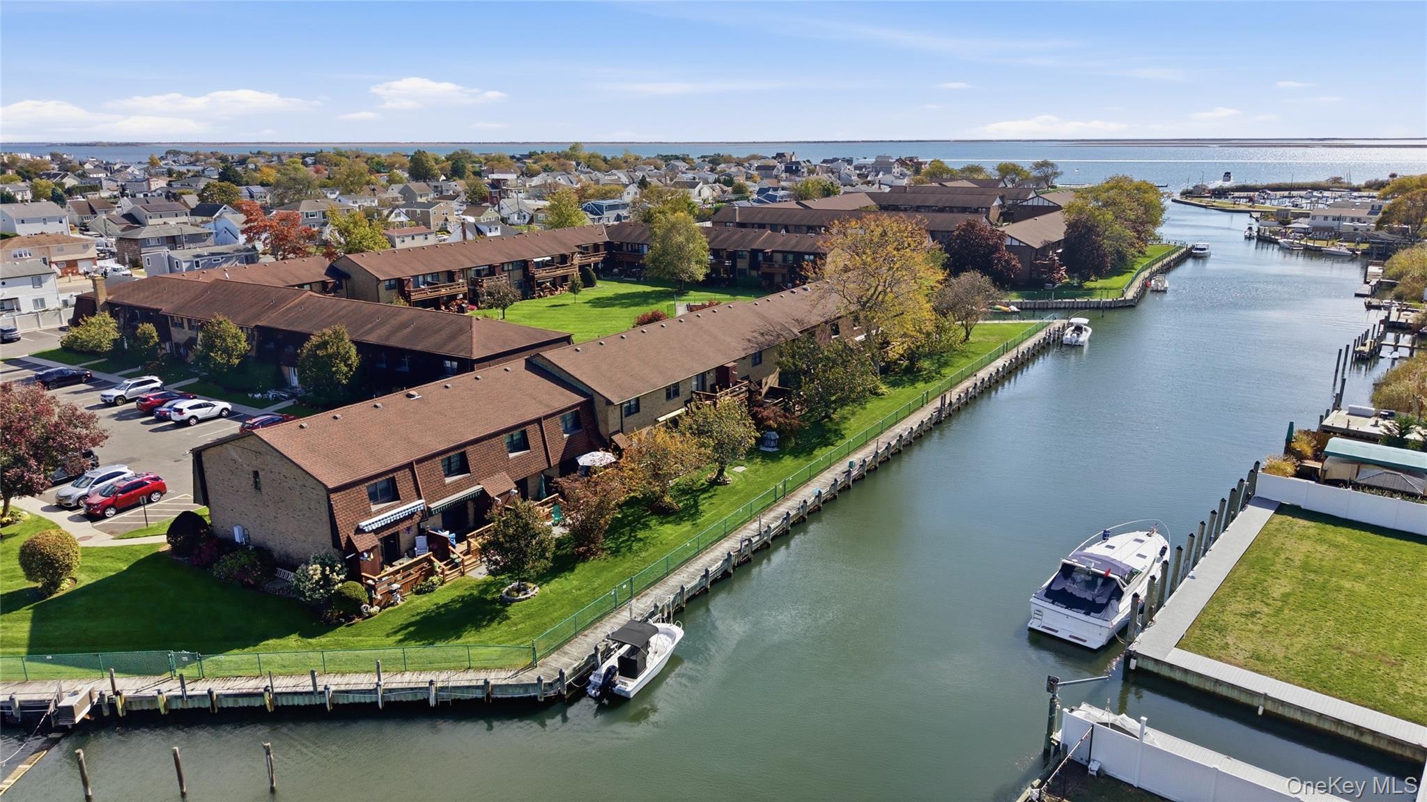 313 Mariners Way Copiague, NY 11726 - Photo 3 of 25 an aerial view of a house with a garden and lake view