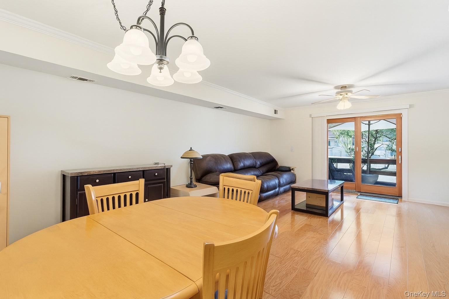 313 Mariners Way Copiague, NY 11726 - Photo 4 of 25 a bedroom with furniture and wooden floor