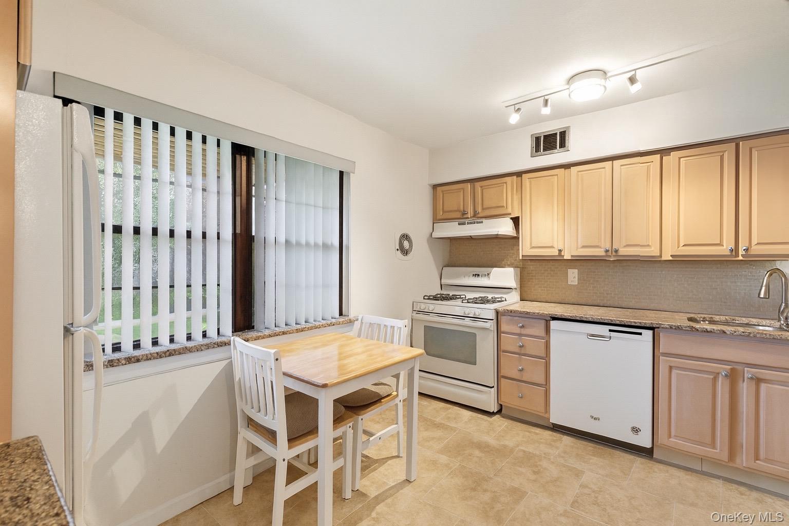 313 Mariners Way Copiague, NY 11726 - Photo 9 of 25 a kitchen with a stove a sink and a refrigerator