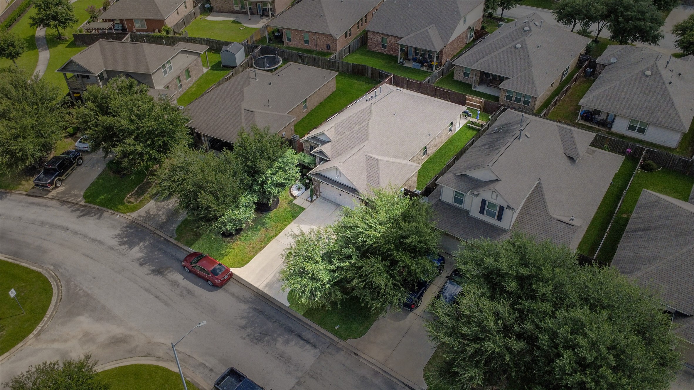 652 Maple Point Drive East Conroe, TX 77301 - Photo 31 of 35 This aerial view shows a cozy single-story home with a well-maintained yard, nestled in a quiet suburban neighborhood. The property has a spacious driveway, mature trees, and is surrounded by similar homes, offering a community feel.