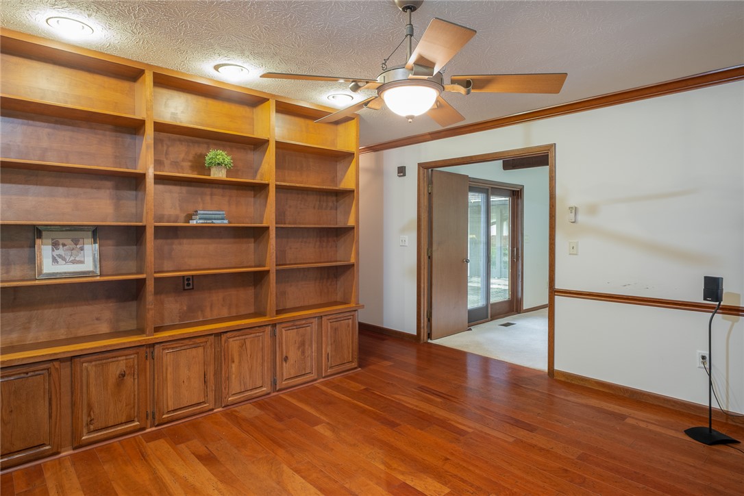 273 North Alpha Bellbrook Road Dayton, OH 45434 - Photo 10 of 43 This versatile room features warm wood flooring and a wall of built-in shelving, ideal for a library or office.
