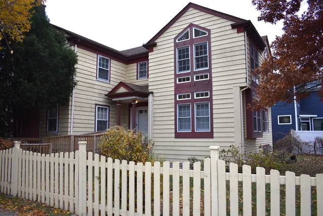 a front view of a house with a fence