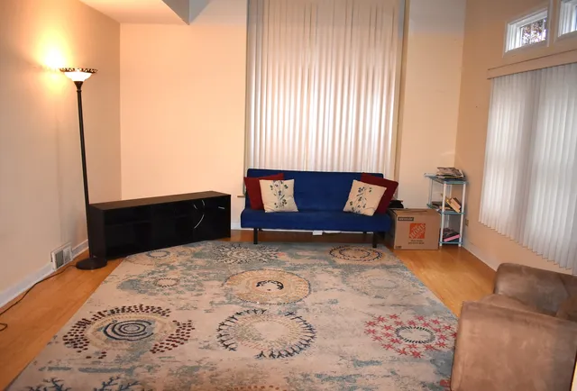 a living room with furniture and a dresser
