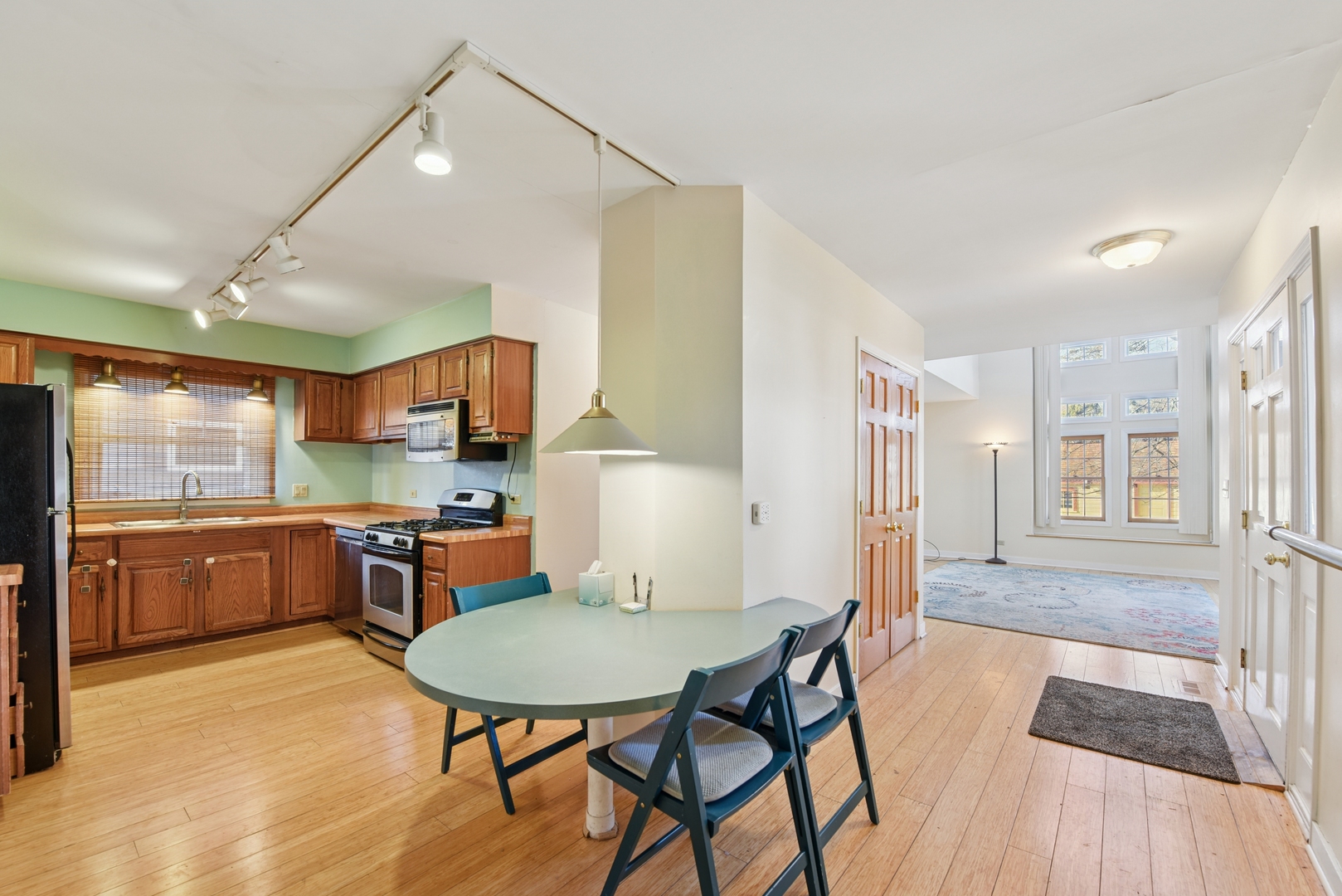 240 North Willow Road Elmhurst, IL 60126 - Photo 10 of 45 a kitchen with stainless steel appliances kitchen island granite countertop a table chairs sink and cabinets