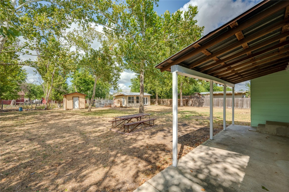 4948 Crossover Road San Marcos, TX 78666 - Photo 15 of 16 Fenced backyard with a patio area and a storage unit