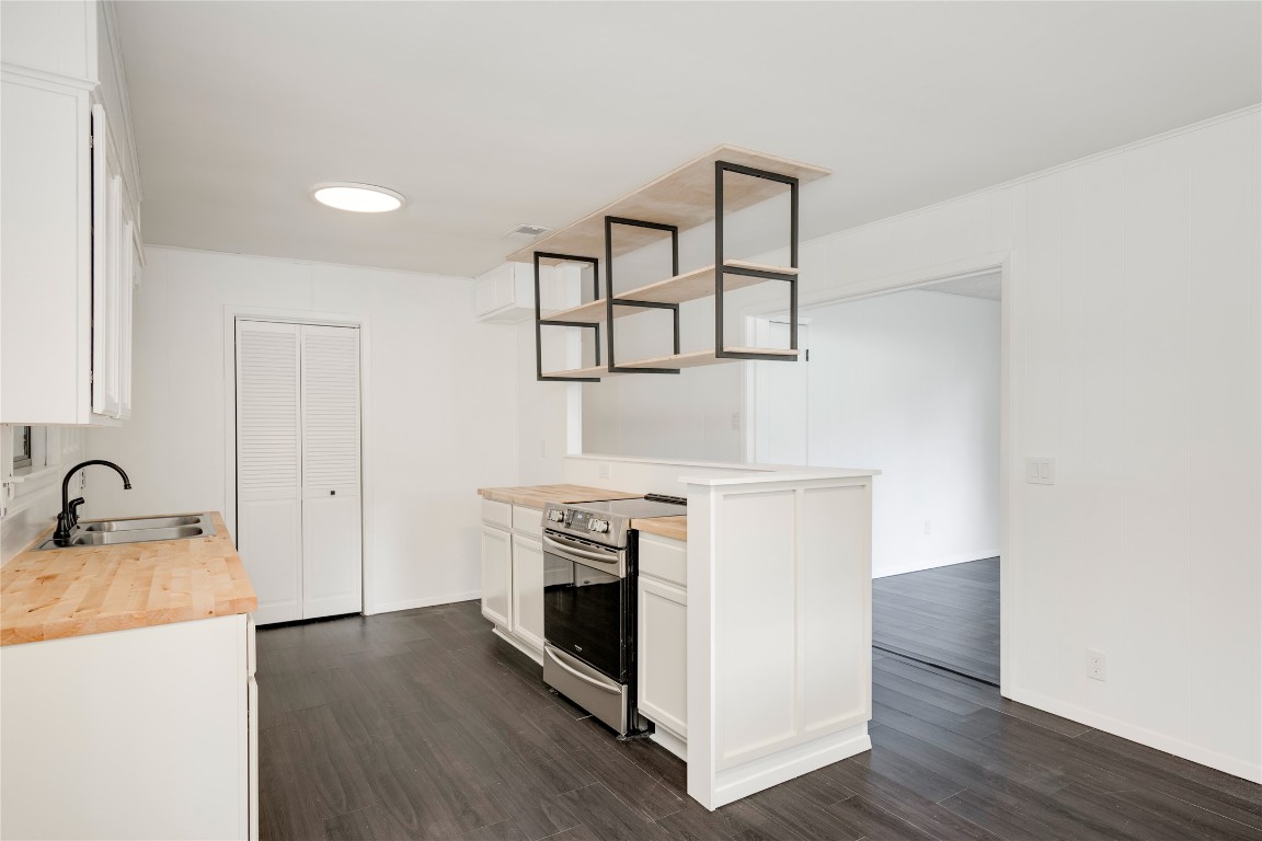 4948 Crossover Road San Marcos, TX 78666 - Photo 5 of 16 Kitchen with wooden counters, white cabinets, open shelves, stainless steel electric stove, and dark wood finished floors