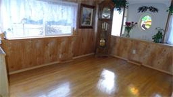 93 Better Way Springfield, MA 01119 - Photo 3 of 25 an empty room with wooden floor and windows