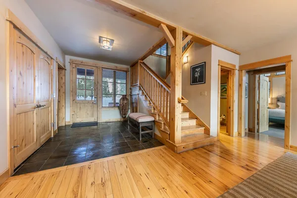 a view of entryway and hall with wooden floor