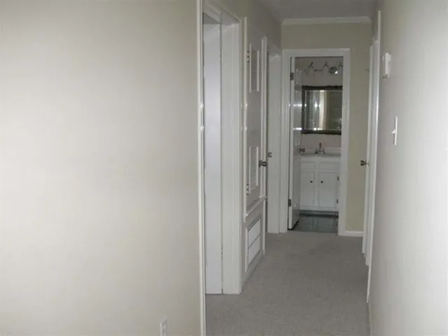 a view of a bathroom from a hallway with toilet