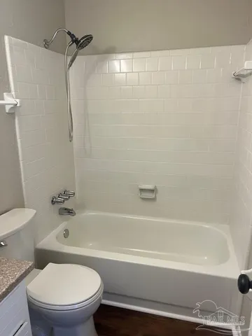 a bathroom with a bathtub and a toilet