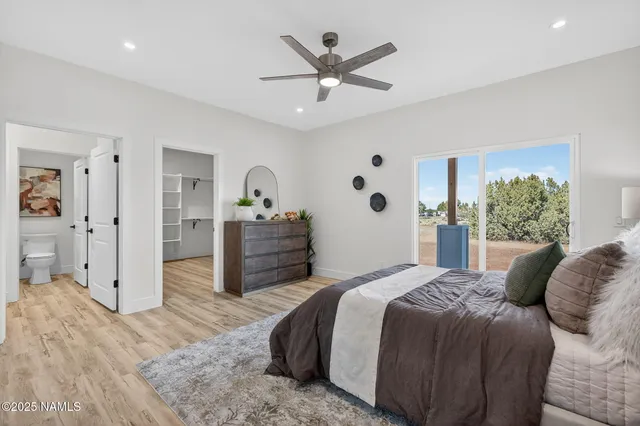 a spacious bedroom with a bed and a view of bathroom