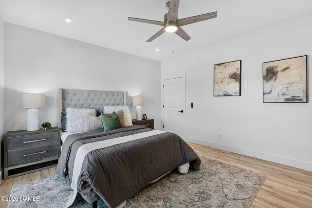 a bedroom with a bed and a painting on the wall