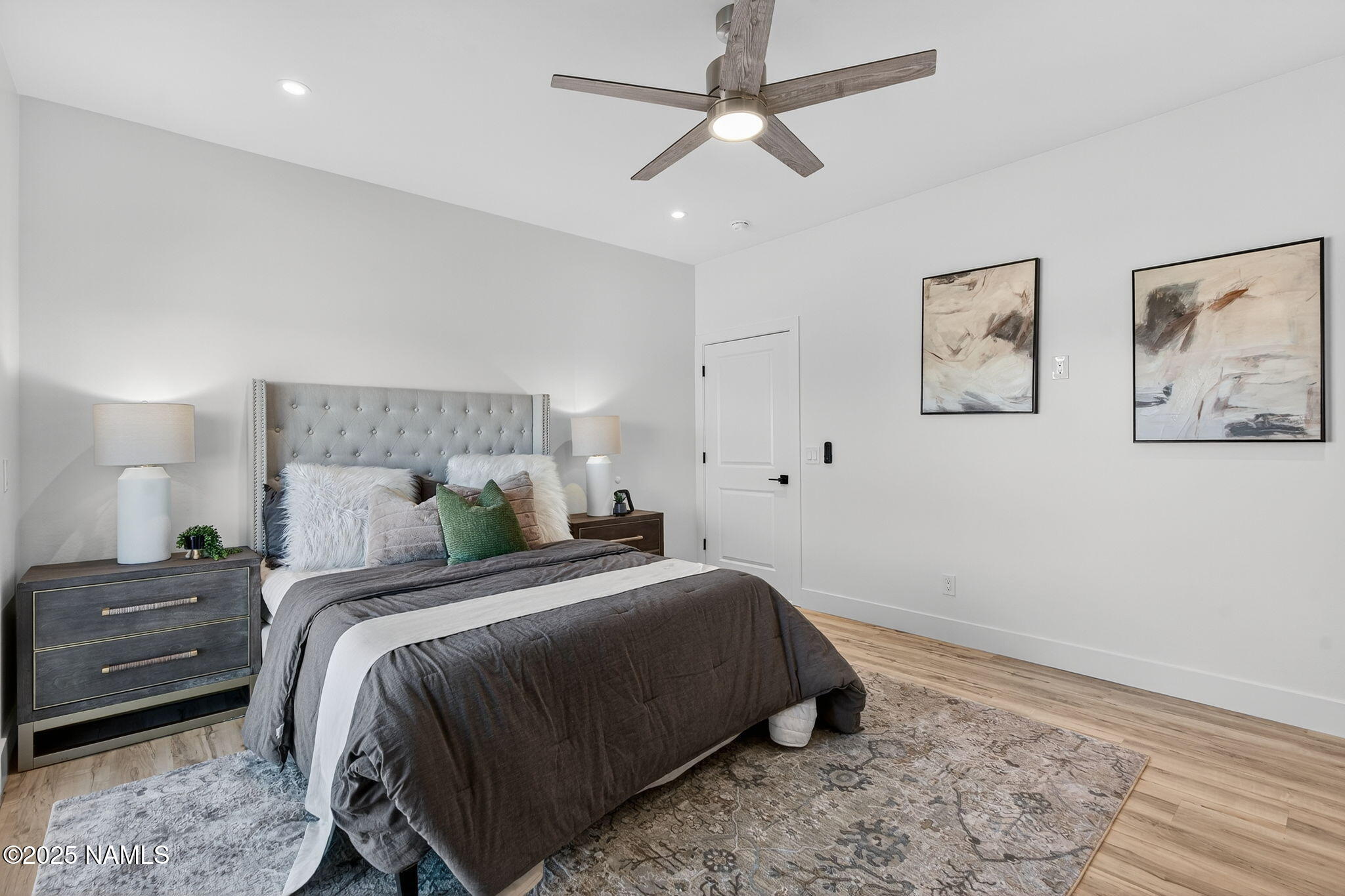 7943 North Red Lake Road Williams, AZ 86046 - Photo 18 of 33 a bedroom with a bed and a painting on the wall