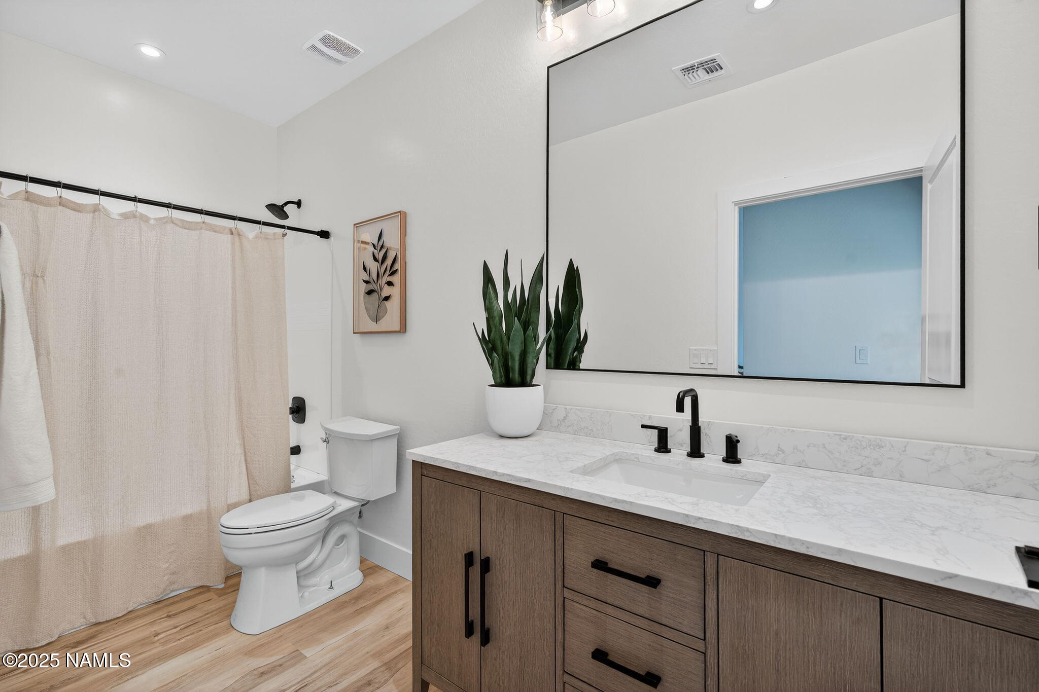 7943 North Red Lake Road Williams, AZ 86046 - Photo 26 of 33 a bathroom with a granite countertop sink a toilet and a mirror
