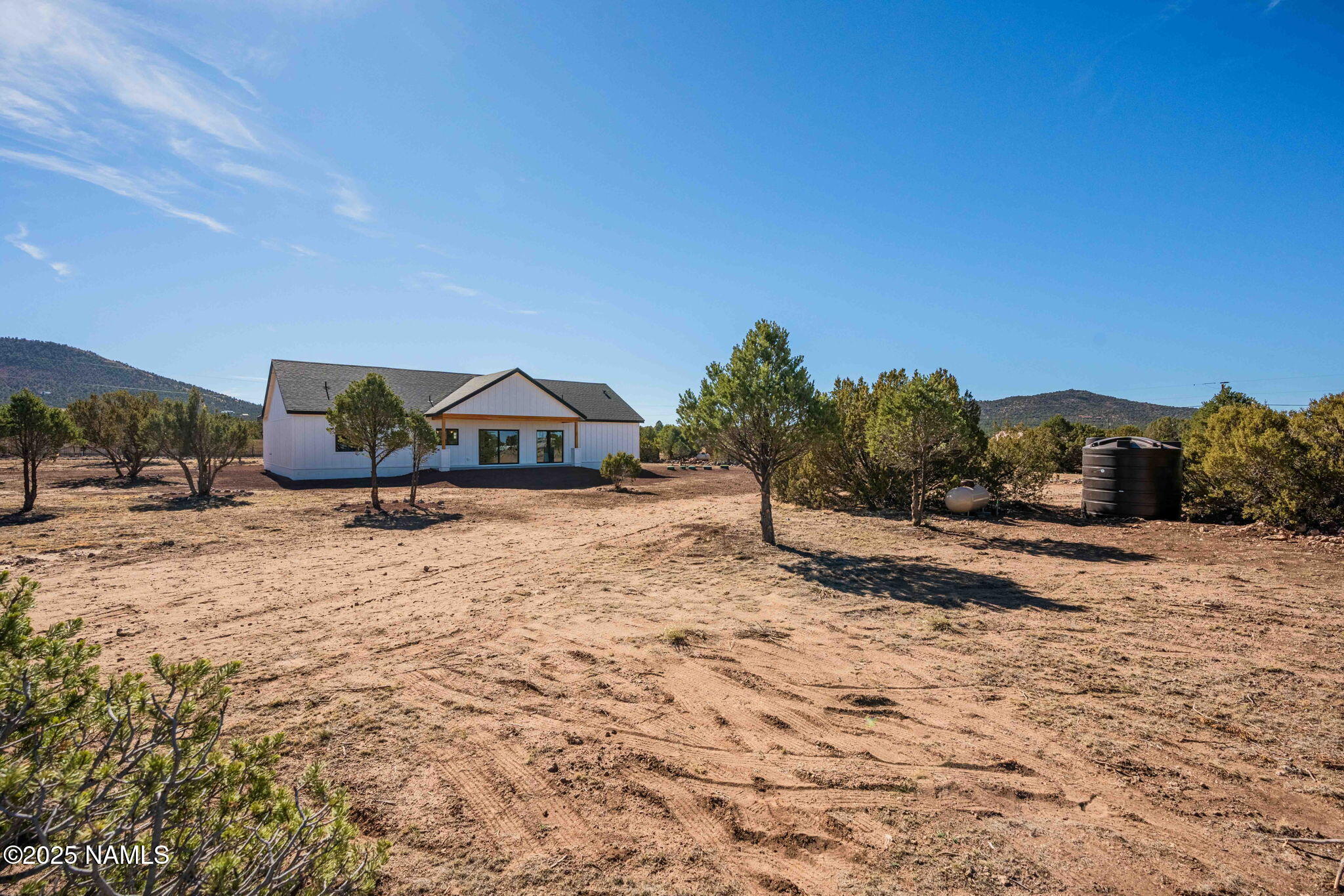 7943 North Red Lake Road Williams, AZ 86046 - Photo 29 of 33 a wooden bench sitting in the middle of a yard