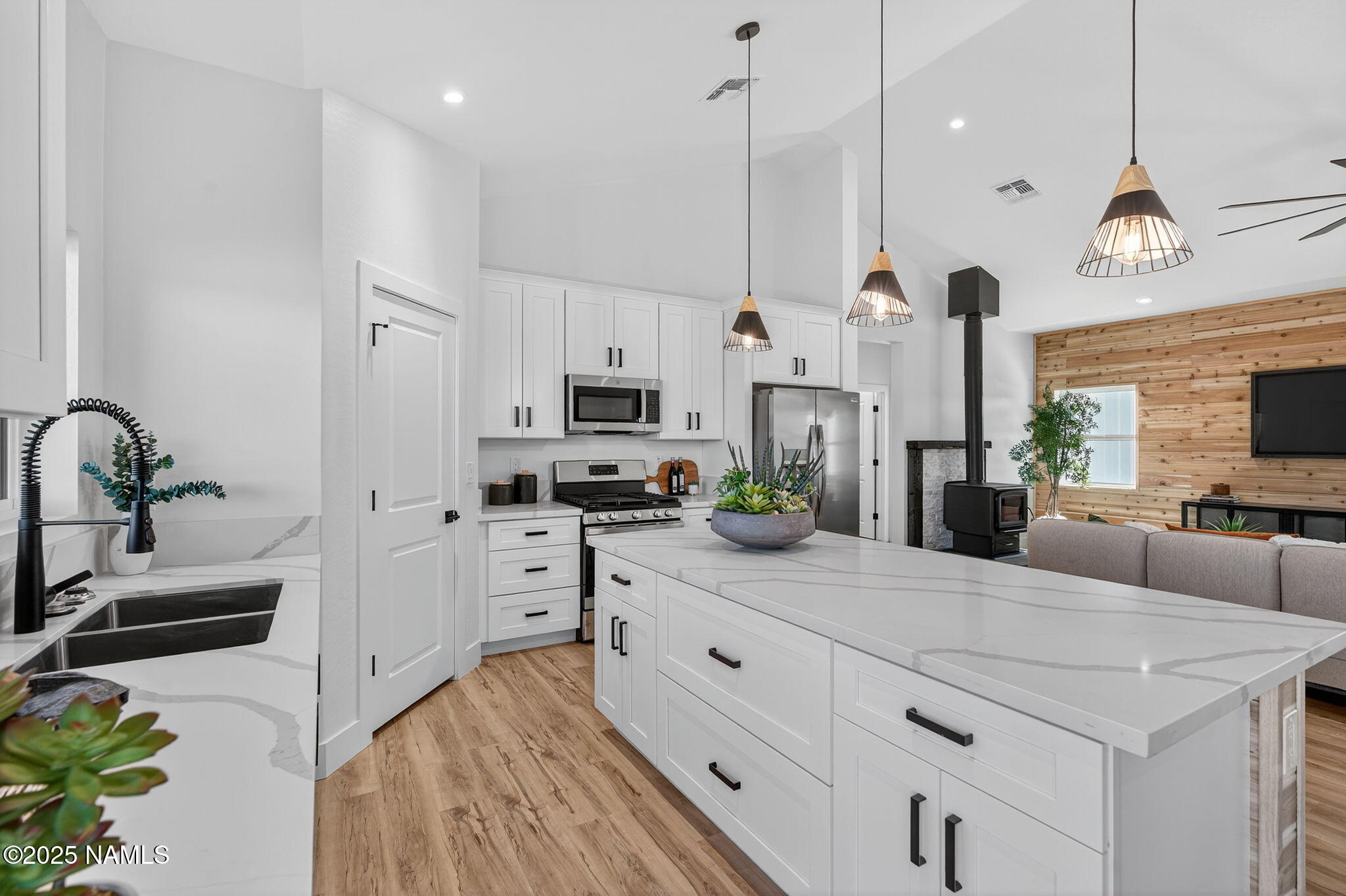 7943 North Red Lake Road Williams, AZ 86046 - Photo 4 of 33 a kitchen with stainless steel appliances kitchen island granite countertop a sink a stove and a refrigerator