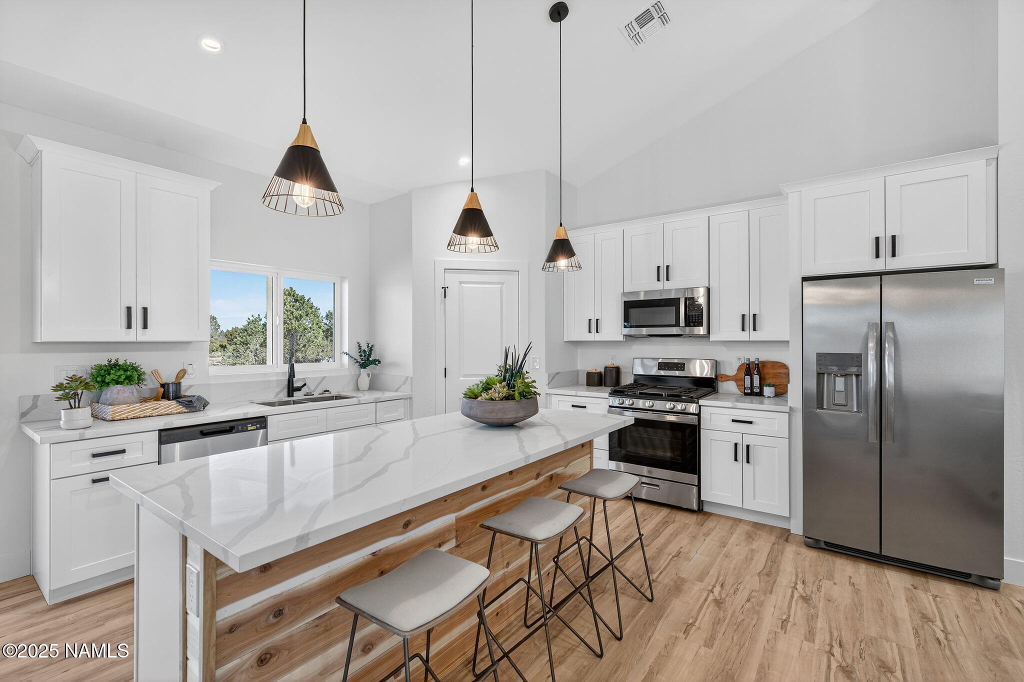 7943 North Red Lake Road Williams, AZ 86046 - Photo 5 of 33 a kitchen with stainless steel appliances granite countertop a refrigerator a sink a stove and white cabinets
