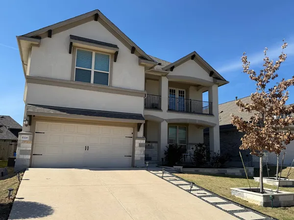 a front view of a house with a yard