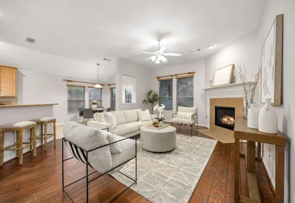 a living room with furniture a fireplace and a table