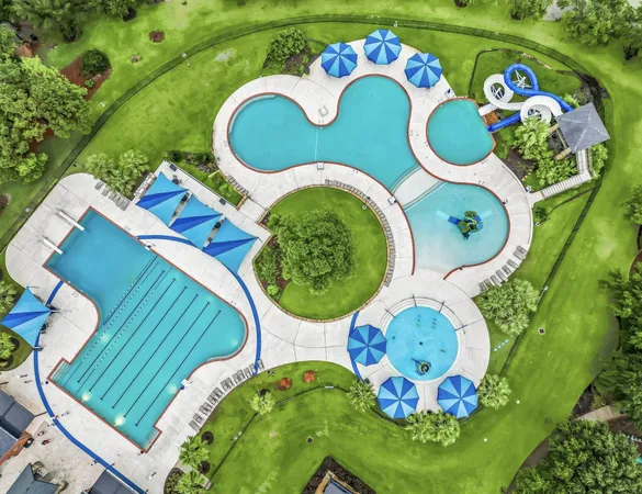 an aerial view of residential houses with outdoor space and lake view