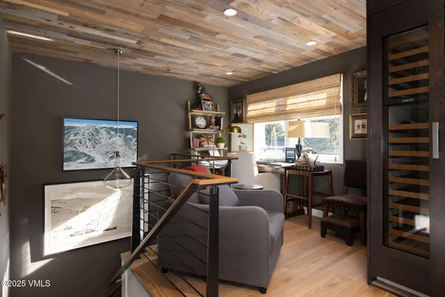 a living room with furniture a flat screen tv and a floor to ceiling window