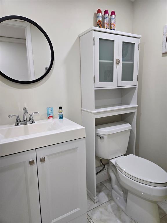 229 Durham East, Unit 229 Deerfield Beach, FL 33442 - Photo 12 of 64 a bathroom with a sink a toilet and a mirror