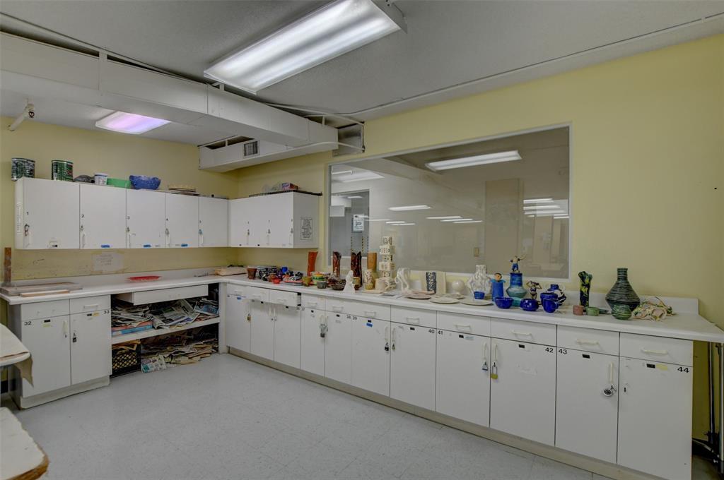 229 Durham East, Unit 229 Deerfield Beach, FL 33442 - Photo 32 of 64 a kitchen with sink and cabinets