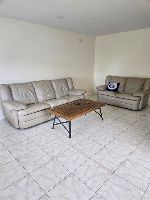 229 Durham East, Unit 229 Deerfield Beach, FL 33442 - Photo 4 of 64 a living room with couch and a table