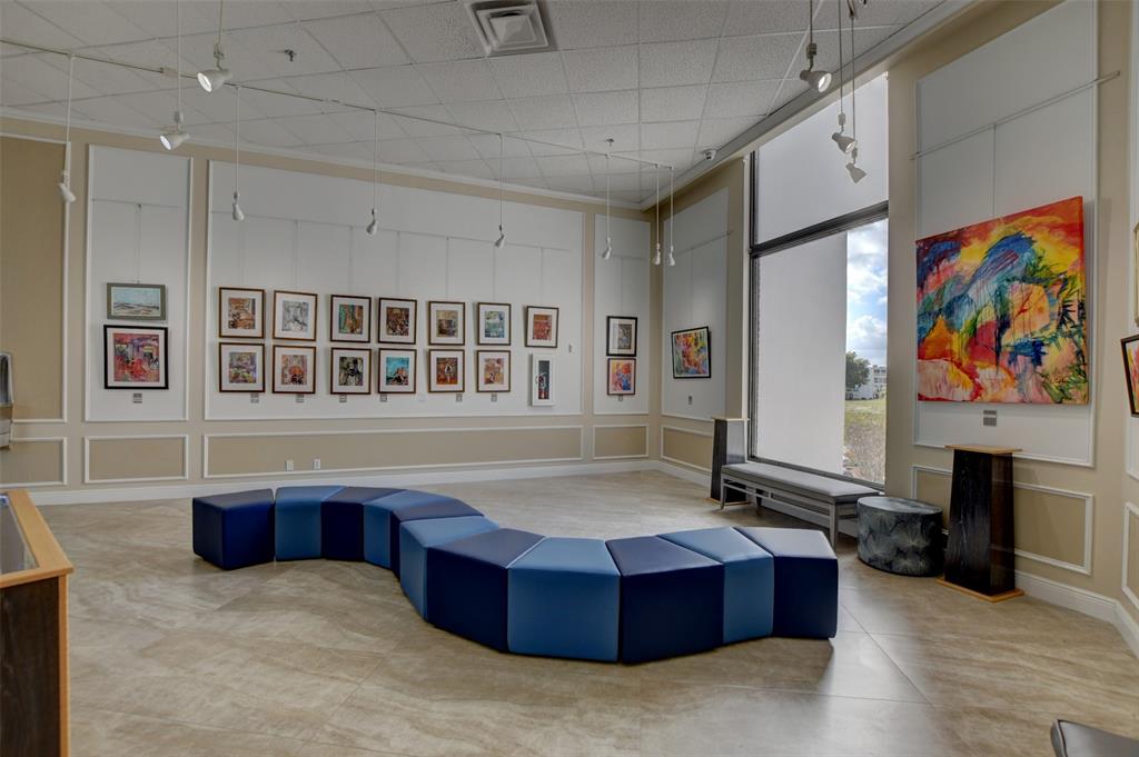 229 Durham East, Unit 229 Deerfield Beach, FL 33442 - Photo 46 of 64 a living room with stainless steel appliances kitchen island granite countertop a couch and cabinets