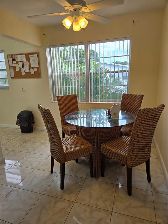 229 Durham East, Unit 229 Deerfield Beach, FL 33442 - Photo 5 of 64 a view of a dining room with furniture and chandelier