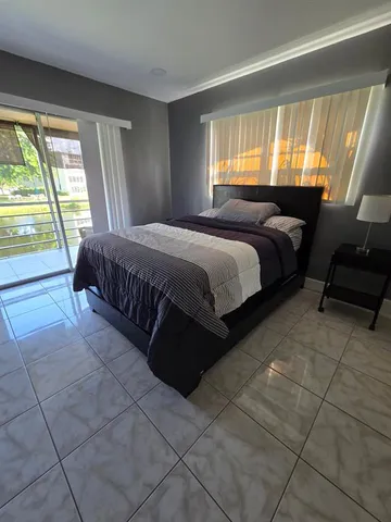 a bedroom with a bed and cabinets