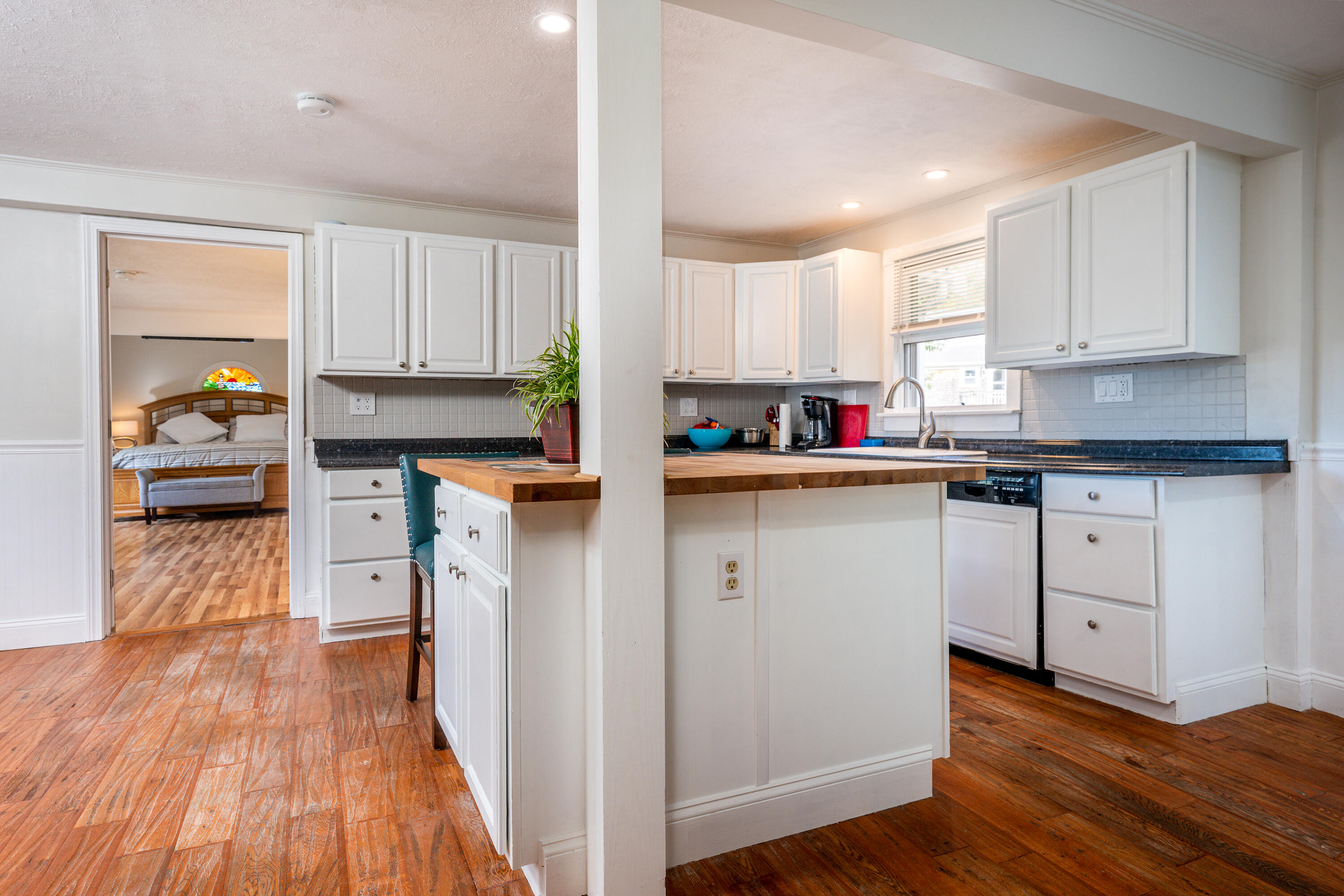 20 Tabor Road Forestdale, MA 02644 - Photo 8 of 27 a kitchen with white cabinets and wooden floor