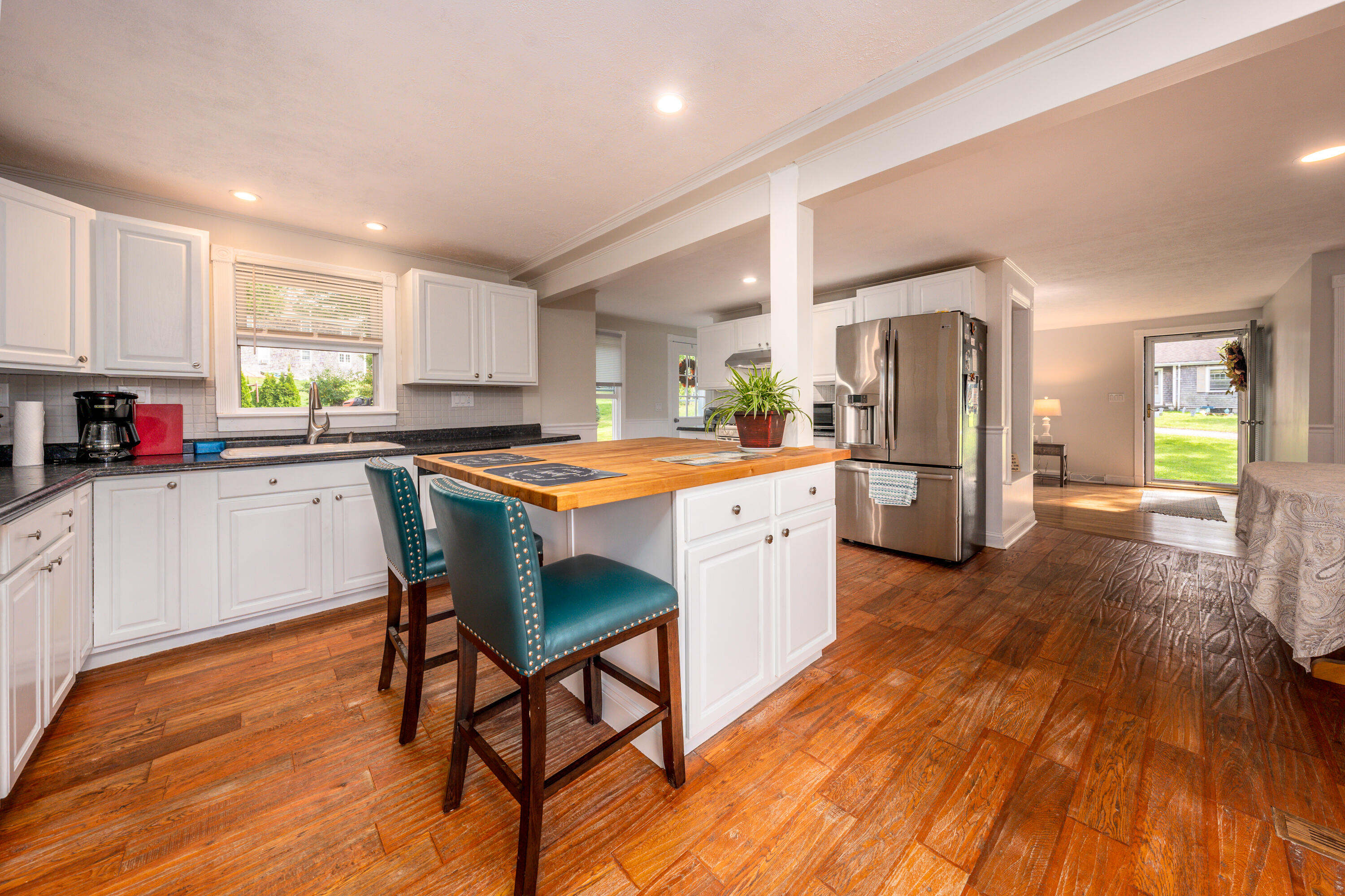 20 Tabor Road Forestdale, MA 02644 - Photo 10 of 27 a kitchen with stainless steel appliances kitchen island wooden floors and white cabinets