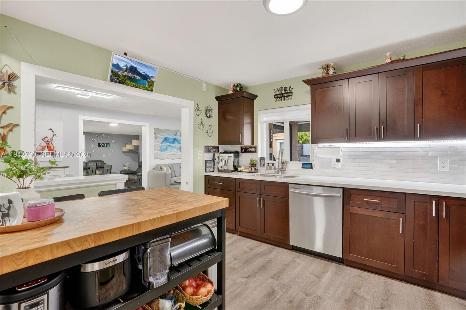 6970 Southwest 24th Street Miramar, FL 33023 - Photo 11 of 39 a kitchen with stainless steel appliances a sink and stove