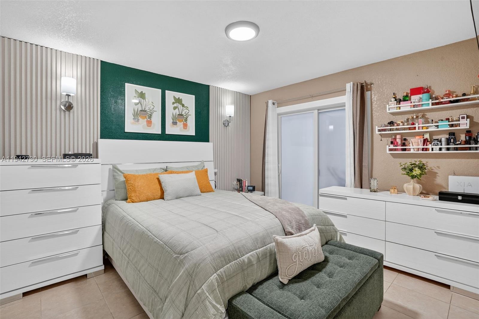 6970 Southwest 24th Street Miramar, FL 33023 - Photo 13 of 39 a bedroom with a bed and a window