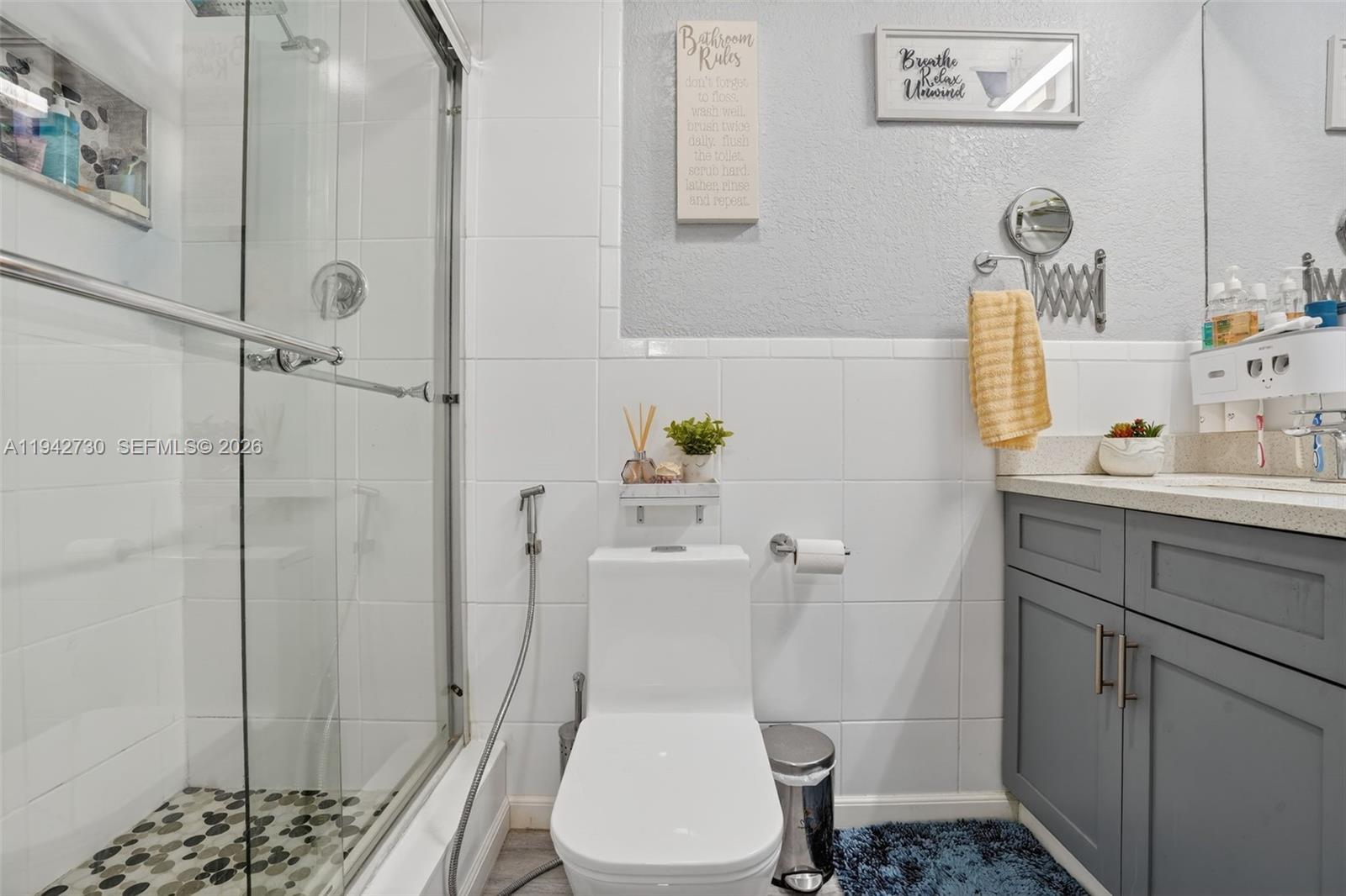 6970 Southwest 24th Street Miramar, FL 33023 - Photo 15 of 39 a white toilet sitting next to a bathroom sink