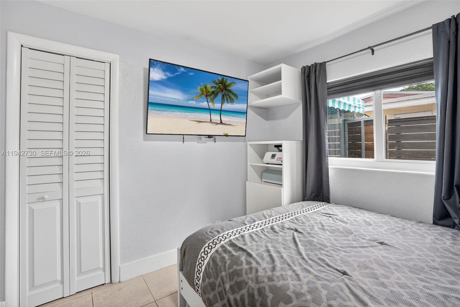 6970 Southwest 24th Street Miramar, FL 33023 - Photo 17 of 39 a bedroom with a bed and a window