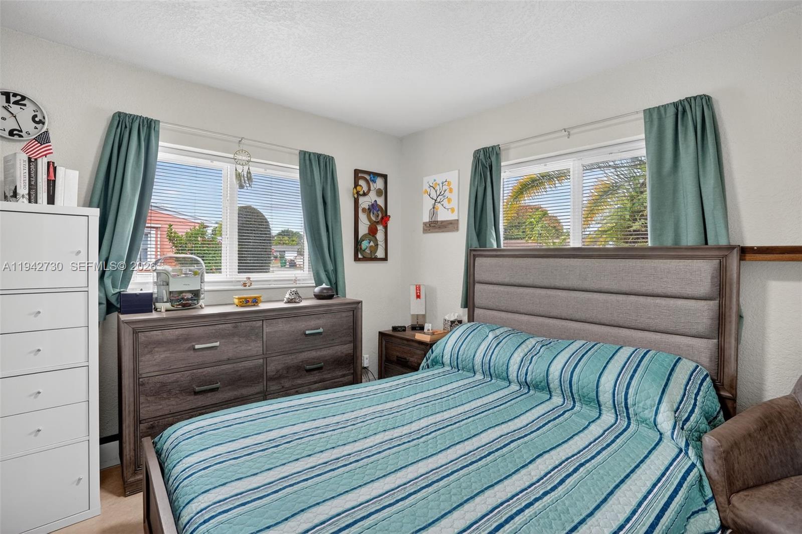 6970 Southwest 24th Street Miramar, FL 33023 - Photo 19 of 39 a bedroom with a bed and a dresser