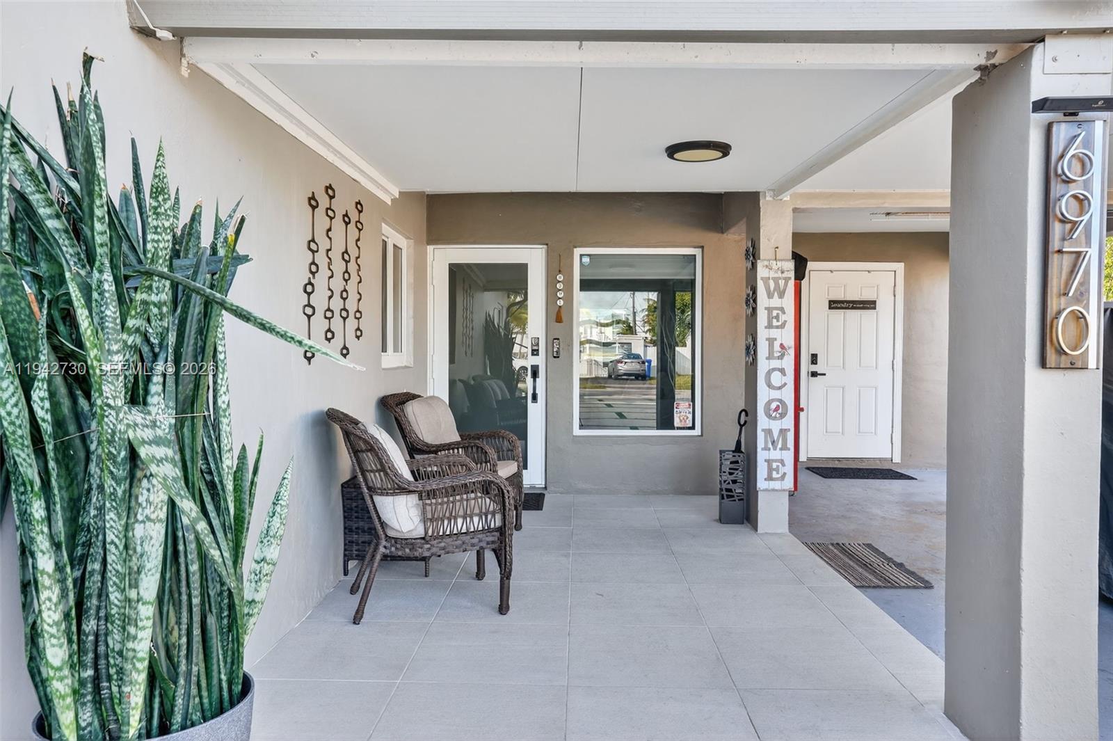 6970 Southwest 24th Street Miramar, FL 33023 - Photo 2 of 39 a balcony with furniture and a potted plant