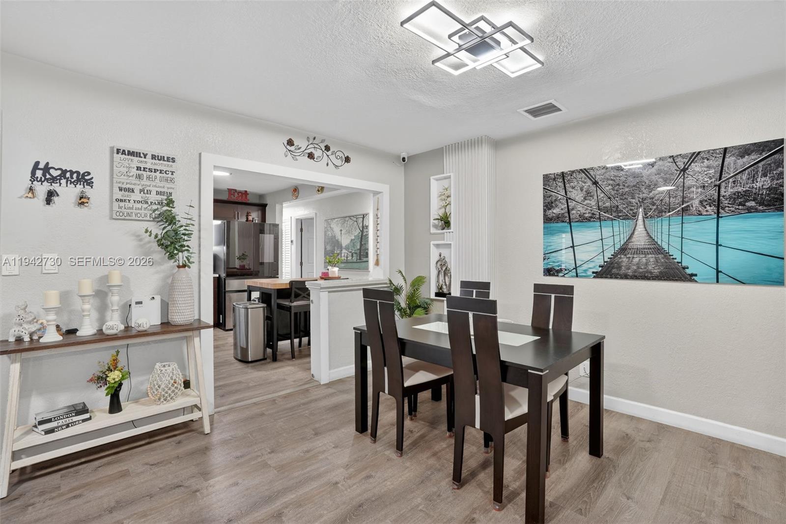 6970 Southwest 24th Street Miramar, FL 33023 - Photo 4 of 39 a view of a dining room with furniture window and wooden floor