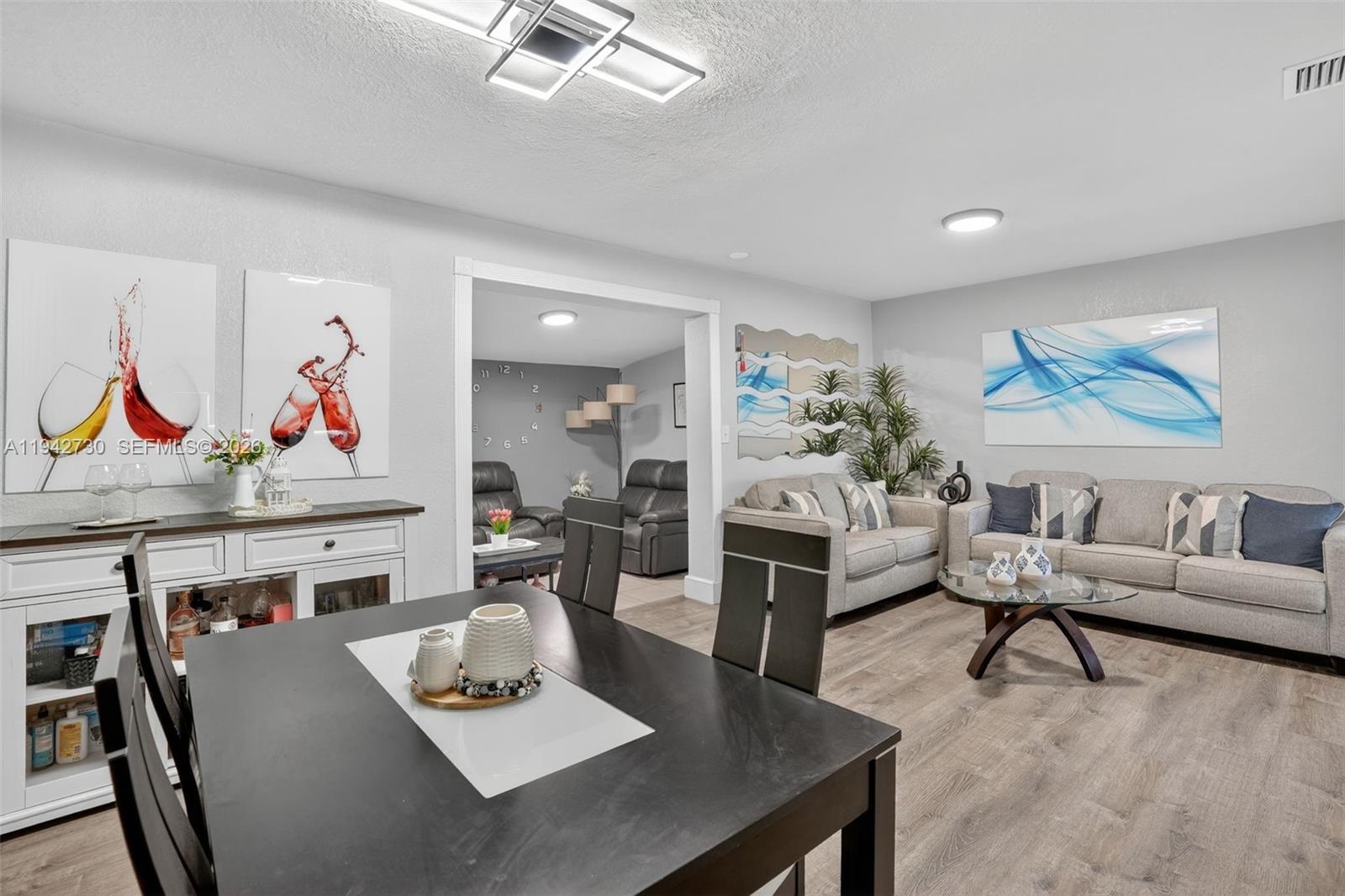 6970 Southwest 24th Street Miramar, FL 33023 - Photo 5 of 39 a living room with furniture and a table
