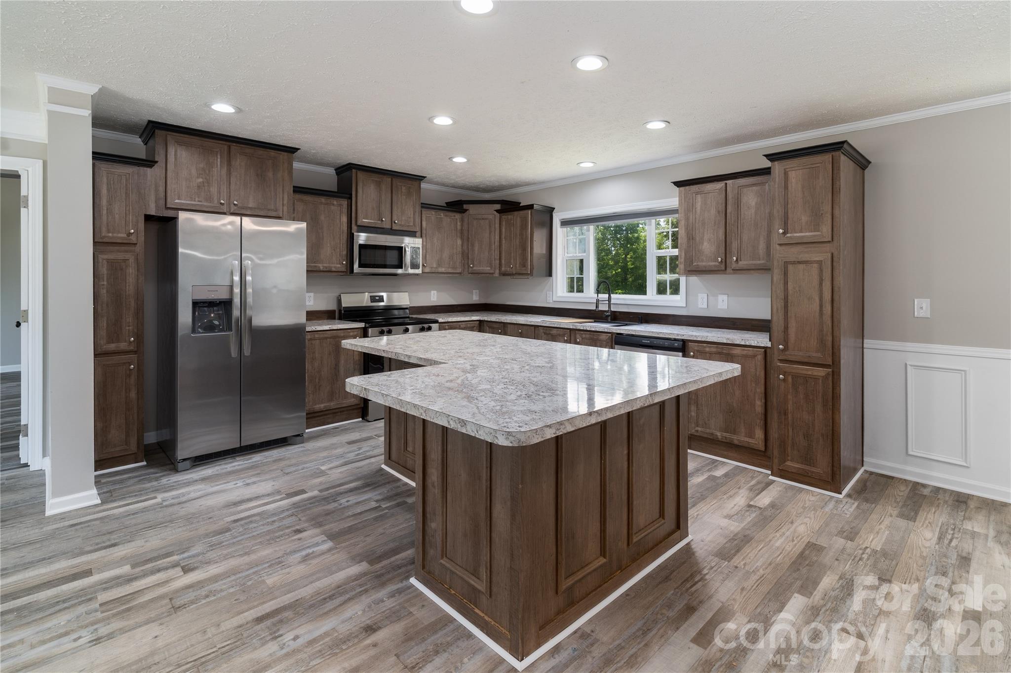 922 Lavender Road Grover, NC 28073 - Photo 12 of 43 a kitchen with kitchen island a sink refrigerator and wooden cabinets
