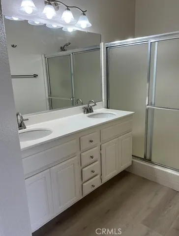 a bathroom with a double vanity sink and mirror